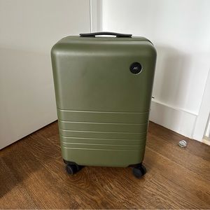 Monos carry on plus in olive green. Used once, ships in original packaging.